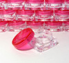 Tiny square cosmetic jars with red caps