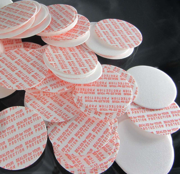 A bunch of Pressure Seal Liners scattered on a black surface.