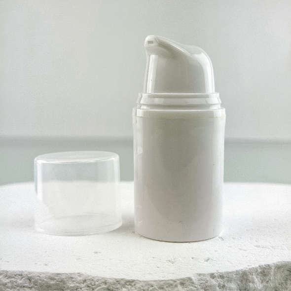 15 ML White Airless Pump Bottle with a clear over cap sitting next to the bottle