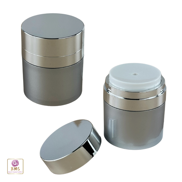 2 Airless Pump Jars Acrylic 50 ml Beauty Packaging Container one with its cap closed and one with its lid open sitting on the side